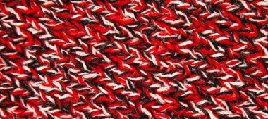 Pattern fabric made of wool. Handmade knitted fabric red black and white wool background texture clipart