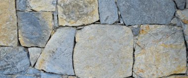 Sağlam mavi ve gri kesim taş duvar, arka planlar için iyi, pürüzsüz dizilmiş.