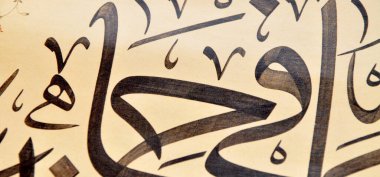 El yapımı kaligrafi kalemi ve İslam sanatı ile kağıt üzerinde İslam kaligrafi karakterleri