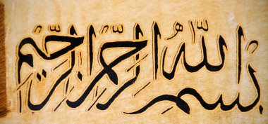 Deri üzerine el yapımı kaligrafi kalemi ve İslam sanatı ile İslam kaligrafi karakterleri.