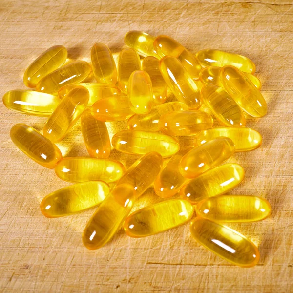 Żółte Tabletki Owalne Oleju Rybnego Desce Krojenia Bambusa Tabletki Owalne — Zdjęcie stockowe
