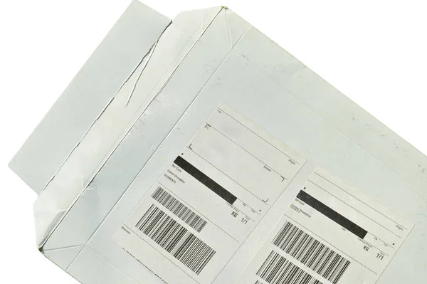 White cardboard paper mail envelope on sticky barcodes. Can be used in company correspondence. Isolated on white background