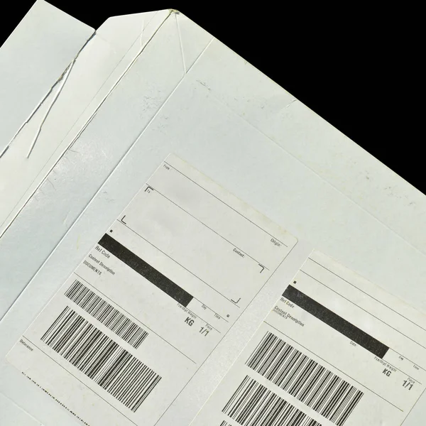 White cardboard paper mail envelope on sticky barcodes. Can be used in company correspondence. Isolated on black background