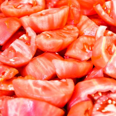 Fresh red yummy tomatoes, peeled and sliced, can be eaten cooked or raw
