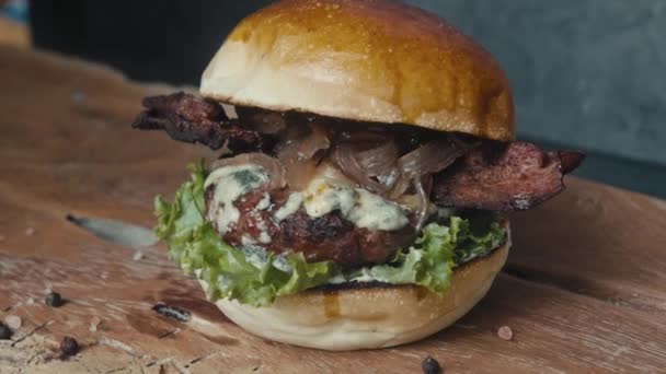 Šéf připravuje hamburger. Zblízka - ruka muže rozmazává omáčku smažený burger za hamburger. Zpomalený pohyb — Stock video