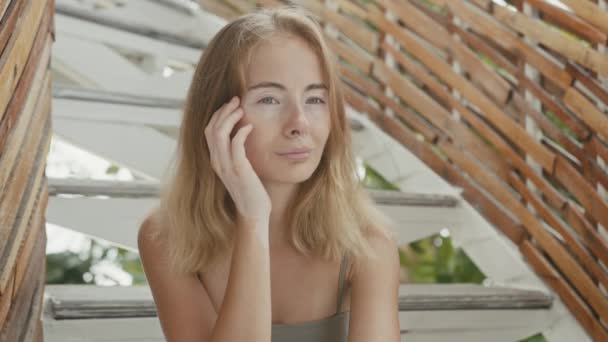 Hezká mladá žena s vitiligovým pigmentem sedí na schodech, dívá se do kamery — Stock video
