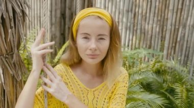 Fashion portrait of cute young woman with vitiligo pigmentation swinging on a swing and looking to camera