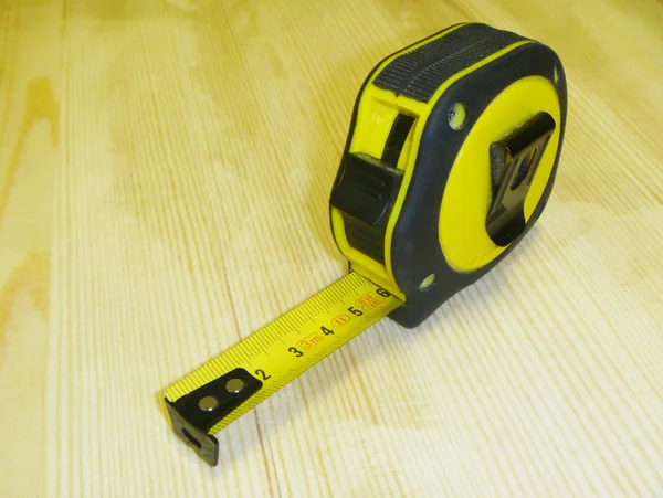 Building instrument tape measure on background of the natural bo — Stock Photo, Image