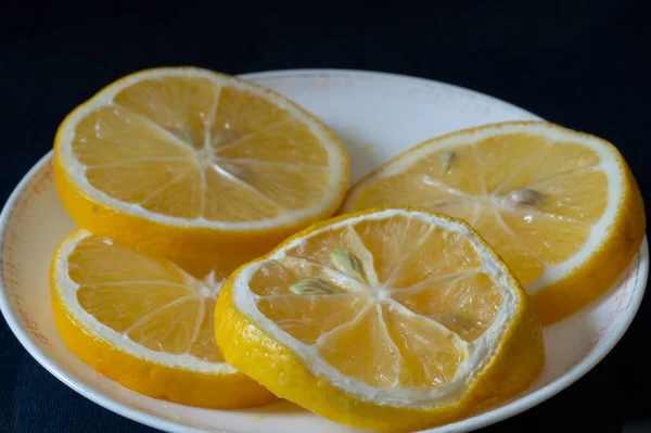 Sliced Lemon Light Plate Food Black Background — Zdjęcie stockowe