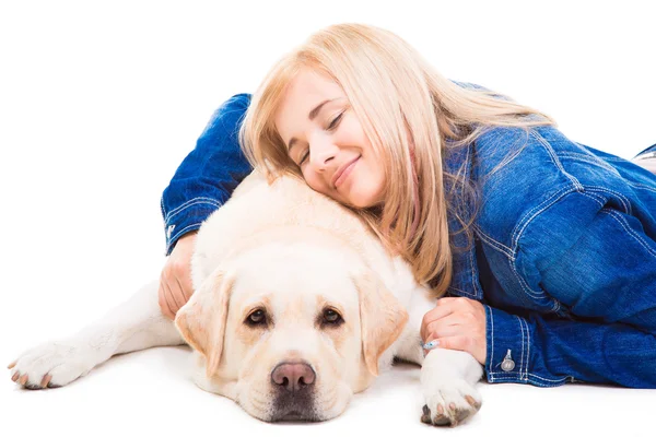 Girl embracing pale-yellow Labrador retriever on the isolated white — Stock Photo, Image