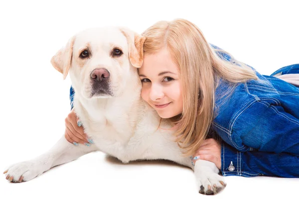 Girl embracing pale-yellow Labrador retriever on the isolated whitegirl emb — Stock Photo, Image