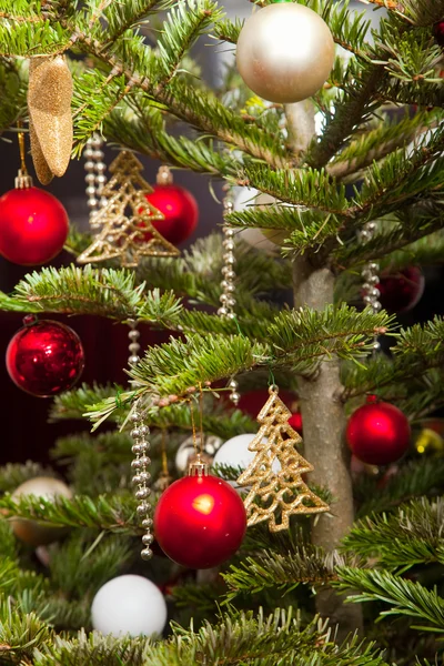 Christmas fir-tree decorated with gold and red balls — Stock Photo, Image