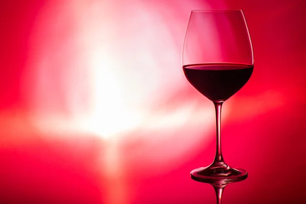 Glass of wine on red — Stock Photo, Image