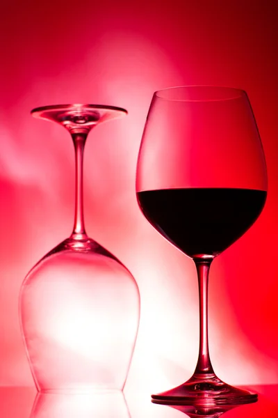 Two glasses of wine on red — Stock Photo, Image