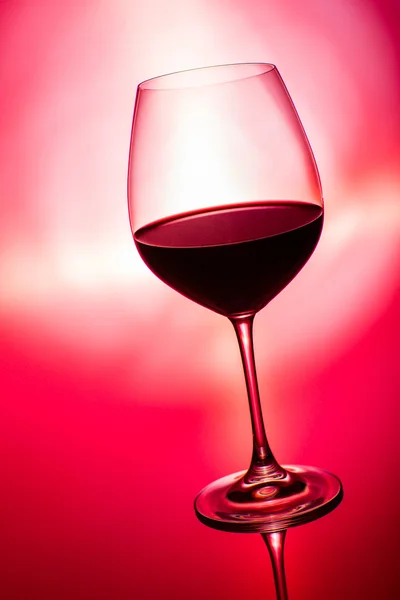 Glass of wine on red — Stock Photo, Image