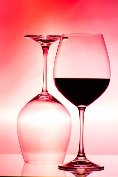 Two glasses of wine on red — Stock Photo, Image