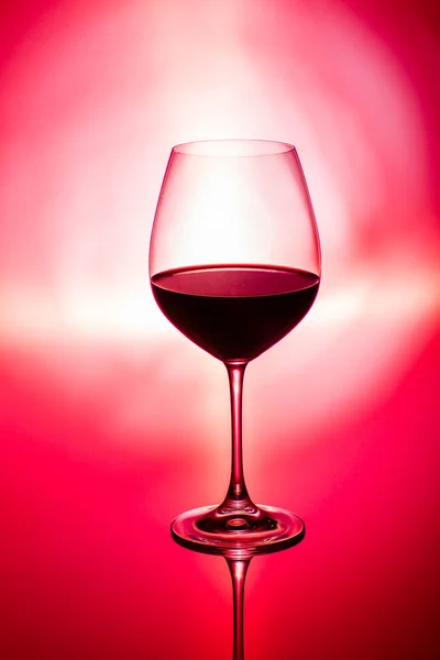 Glass of wine on red — Stock Photo, Image