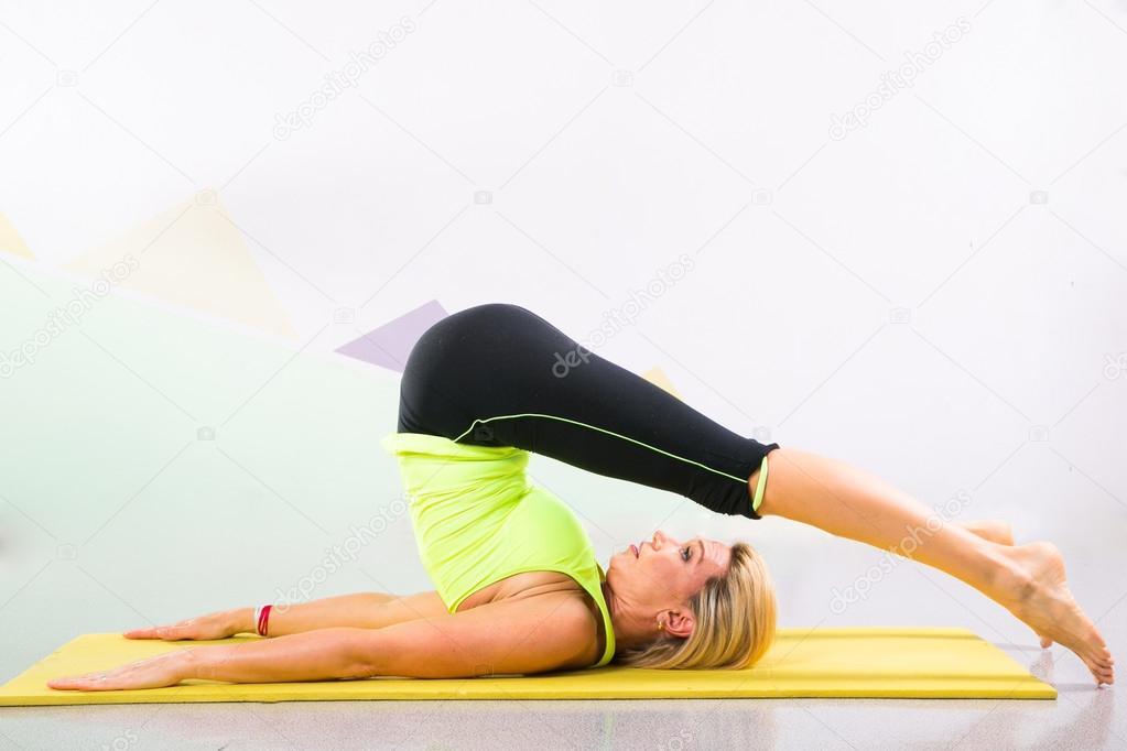 Beautiful Pilates Instructor With Yellow Yoga Mat Stock Photo