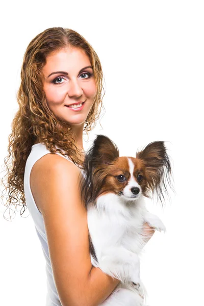 Beautiful girl with cute papillon dog on isolated white — Stock Photo, Image