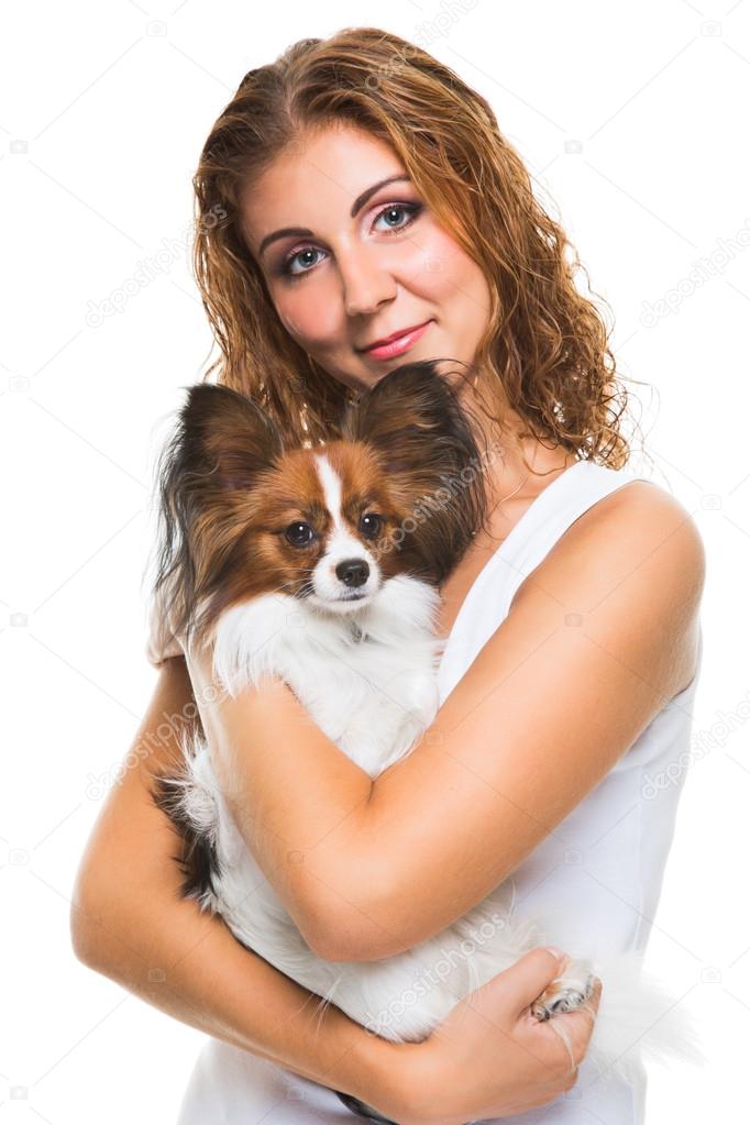 beautiful girl with cute papillon dog on isolated white