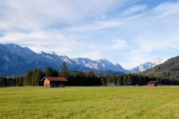 Wooden hut on alpine meadows in morning — Stock Photo, Image