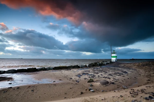 Lighthouse by North sea at sunset — Stock Photo, Image