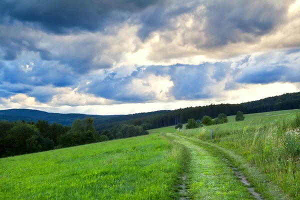 Dramatic cloudscape over rural road — Stock Photo, Image