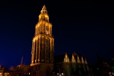 famous Martinitoren (Martini tower) in Groningen at night clipart