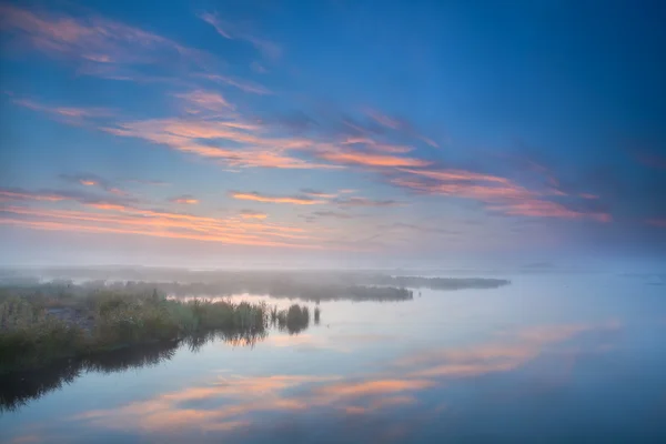 Himmel spiegelt sich im See am nebligen Morgen — Stockfoto