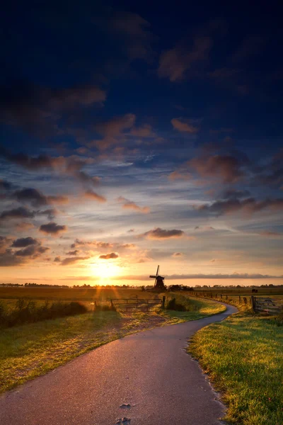 Warm summer sunrise and windmill — Stock Photo, Image