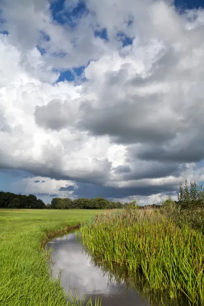 Storm clouds over river — Stock Photo, Image