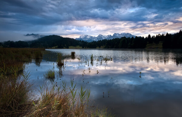 clouded sunrise over Geroldsee in Bavarian Alps