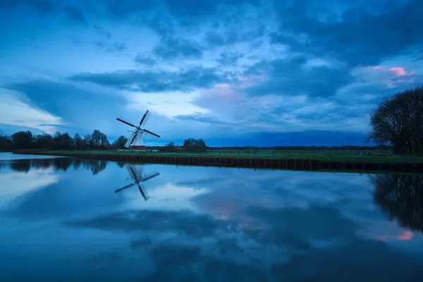 Beautiful cloudscape over windmill and river — Stock Photo, Image