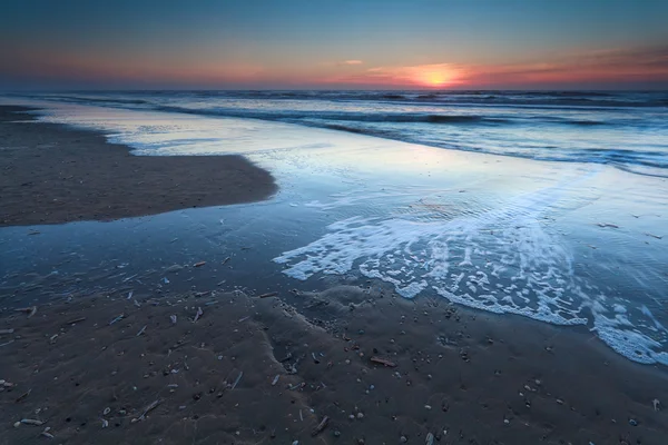 Sunset over sand beach on North sea — Stock Photo, Image