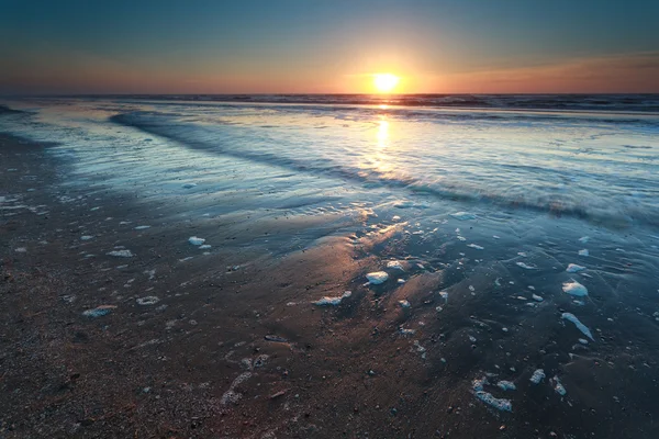 Sunset over North sea sand beach — Stock Photo, Image