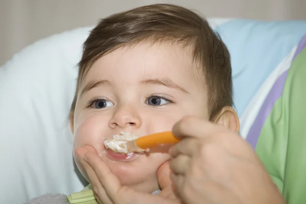 Mother feeding her happy little cute boy — Stock Photo, Image