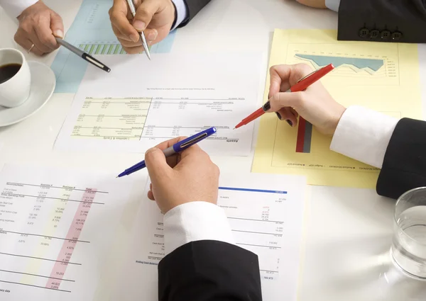 Businesspeople working together at meeting, discussing document — Stock Photo, Image