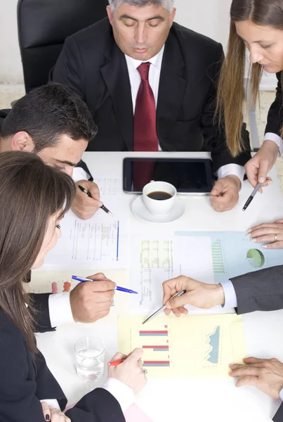 Businesspeople working together at meeting, discussing document — Stock Photo, Image