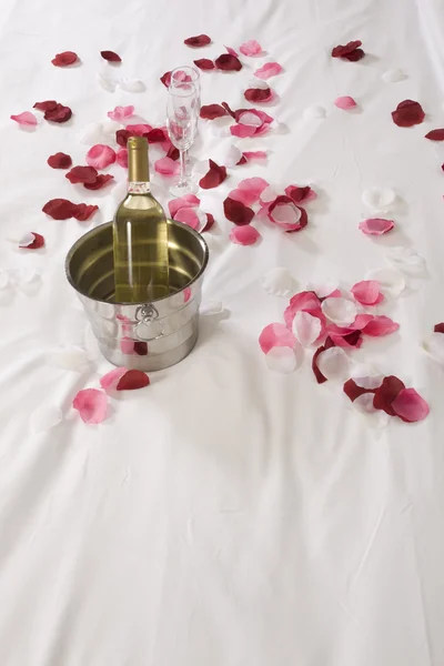 Otel odasında büyük yatak ve kırmızı çiçekler — Stok fotoğraf