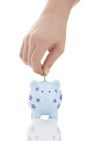 Savings - Piggy bank and hand with coin — Stock Photo, Image