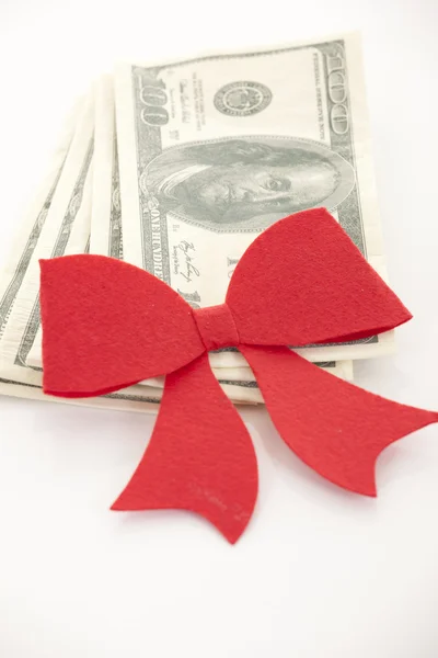 Money, gift wrapped in red bow and ribbon, one hundred dollars b — Stock Photo, Image