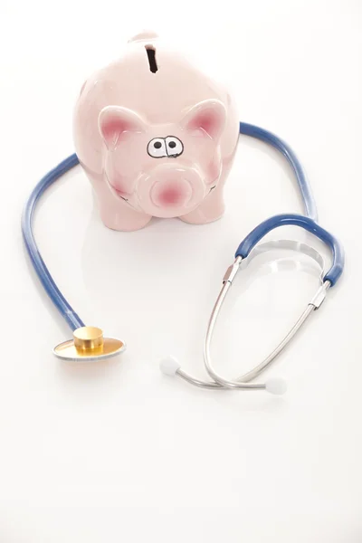 Piggy bank and stethoscope isolated on white — Stock Photo, Image