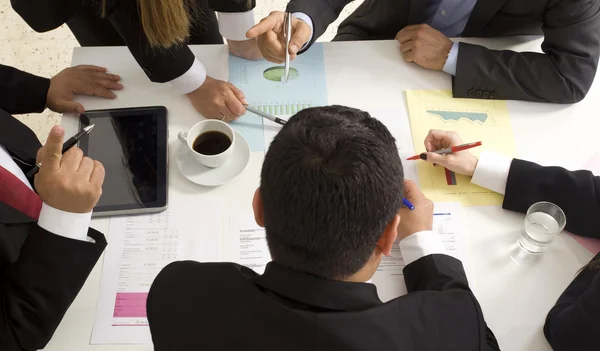 Businesspeople working together at meeting, discussing document — Stock Photo, Image