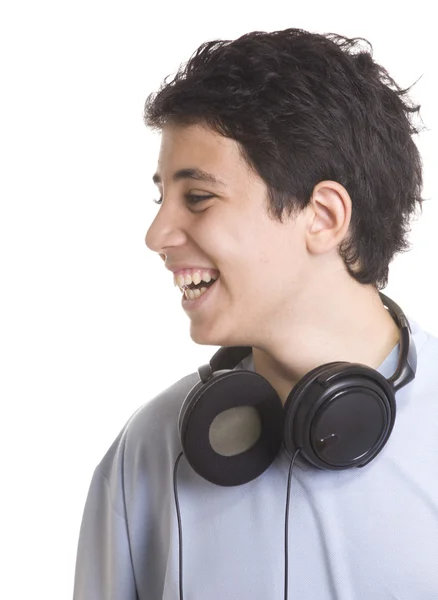 Retrato de um menino doce ouvindo música em fones de ouvido um — Fotografia de Stock