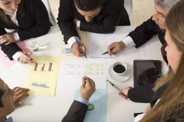 Businesspeople working together at meeting, discussing document — Stock Photo, Image