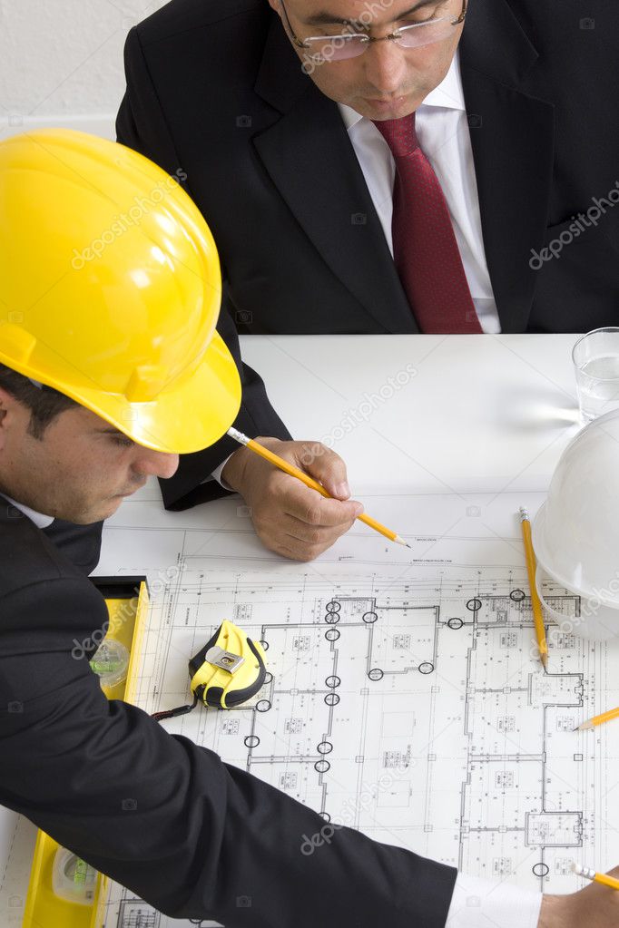 Above view of architects sitting at the table and discussing des