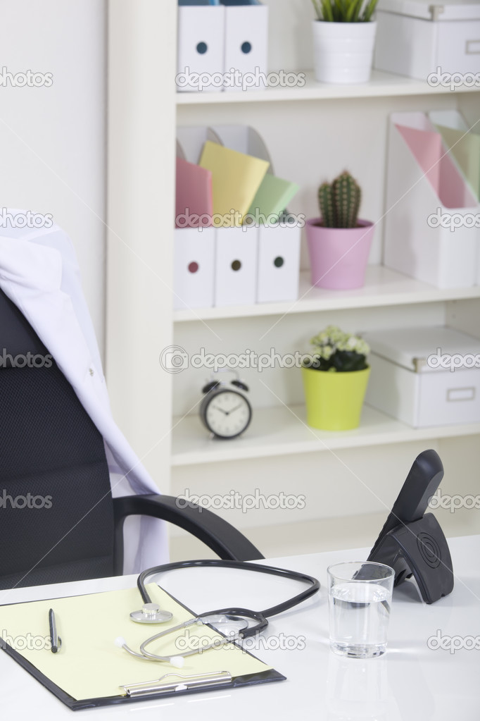 Doctor office table desk and black chair with stethoscope and w