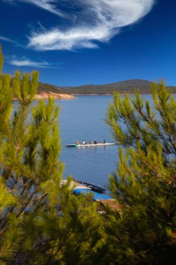 rowing team paddles on the tranquil sea. High quality photo