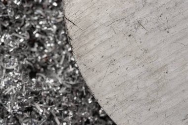 Gülen makinenin talaşı üzerinde büyük magnezyum çubuğu. Makro atış. Üst görünüm endüstriyel yakın çekim fotoğrafı. Girdap magnezyum talaşlarının üzerindeki metal çıkıntının fotoğrafı. Endüstriyel teknoloji atölyesi. Teknoloji konsepti geçmişi.