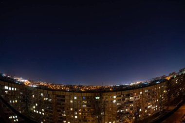 Night starry sky city view from roof high rise building fisheye. Night starry cityscape.